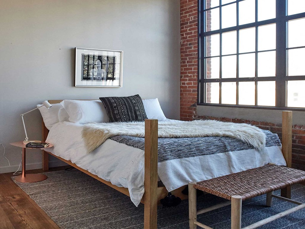 a bedroom with a bed and a window