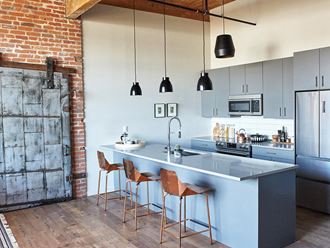 a kitchen with a blue island and three stools
