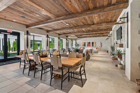 A dining room with a long table and chairs.