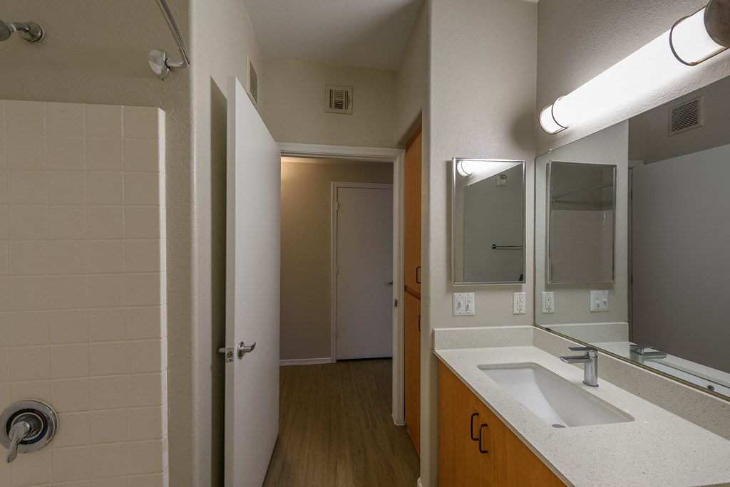 a bedroom with a medium sized bed and a mirror