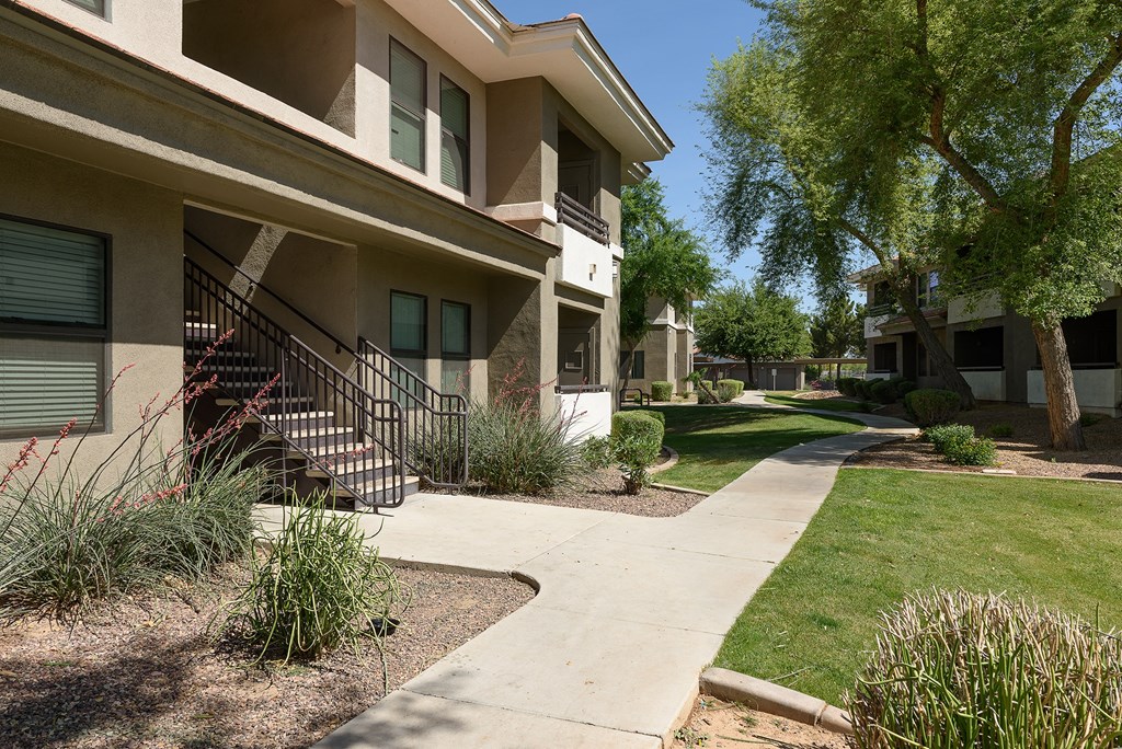 a walkway in front of an apartment building