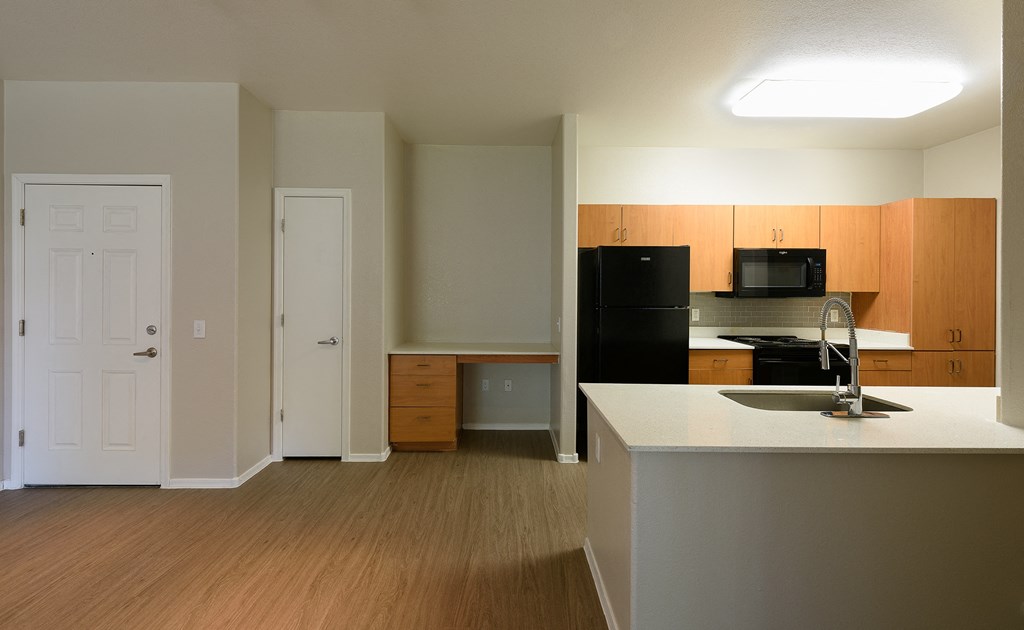 a kitchen and living room in an apartment