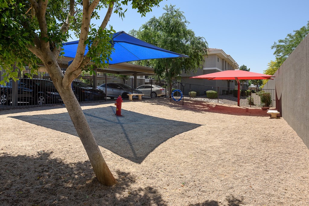 a playground with a fire hydrant and umbrella