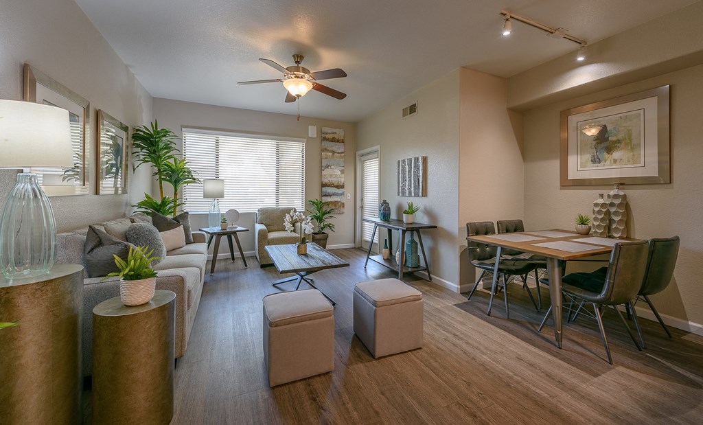 a living room and dining room with a ceiling fan