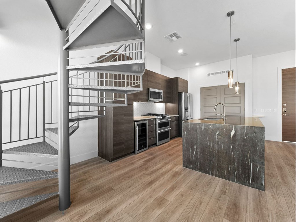 a kitchen with a spiral staircase and a marble counter top at Scottsdale Grand, Scottsdale, AZ