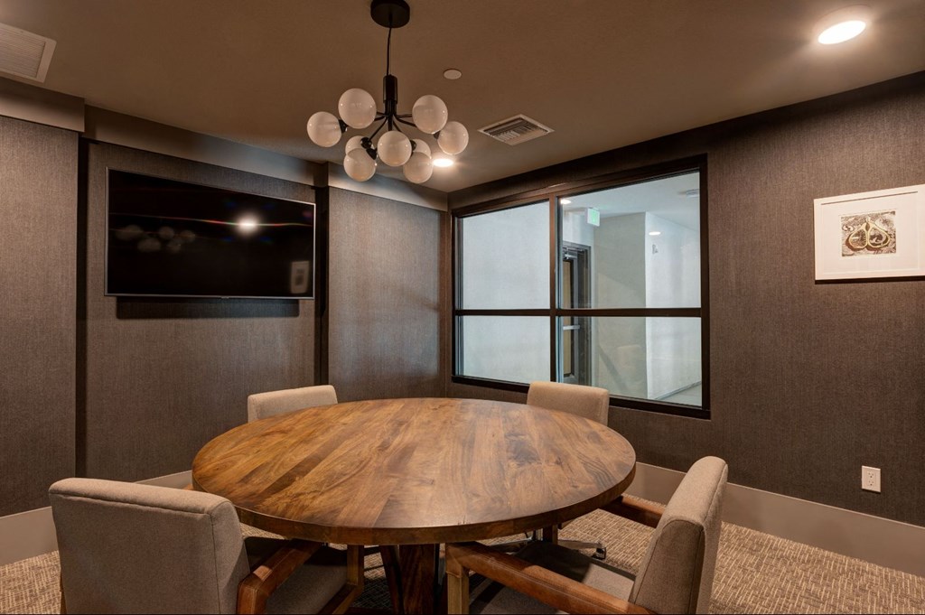 a dining room with a wooden table and chairs at Scottsdale Grand, Scottsdale