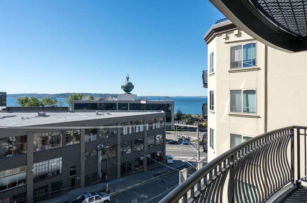 A building with a balcony overlooking the ocean.