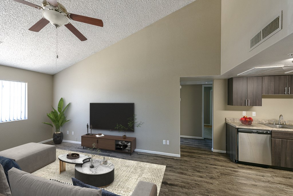 an open living room and kitchen with a ceiling fan