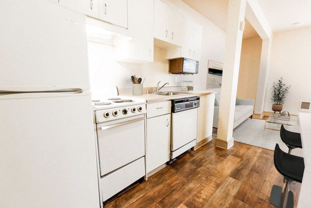 a kitchen with white appliances and a wood floor at Zindorf, Seattle, Washington
