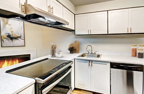 a kitchen with a stove top oven and a sink