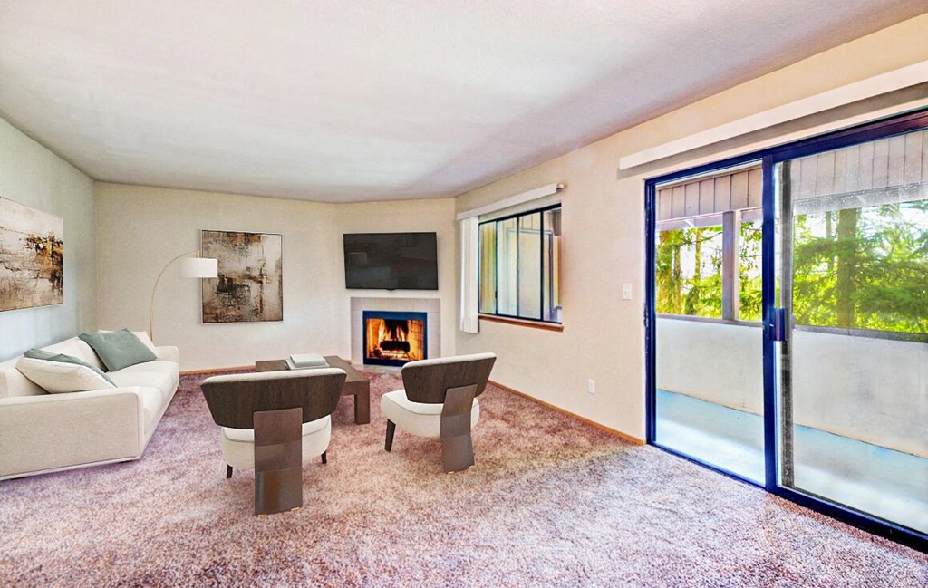 a living room with a couch and chairs and a fireplace at Autumn Village, Washington