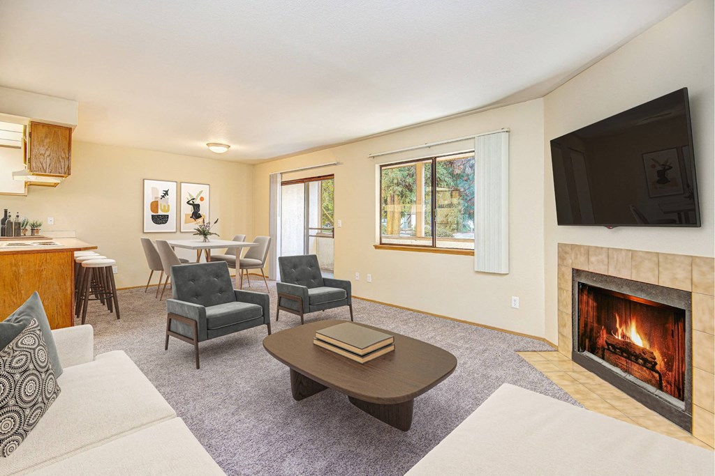 A living room with a fireplace and a television. at Autumn Village, Washington