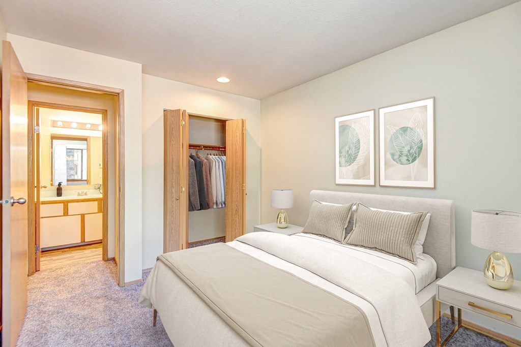 A bedroom with a large bed and a walk-in closet. at Autumn Village, Washington, 98354