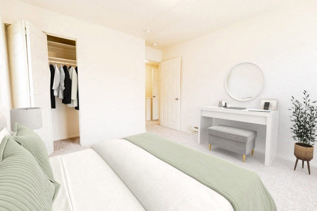 a bedroom with a bed and a vanity with a mirror