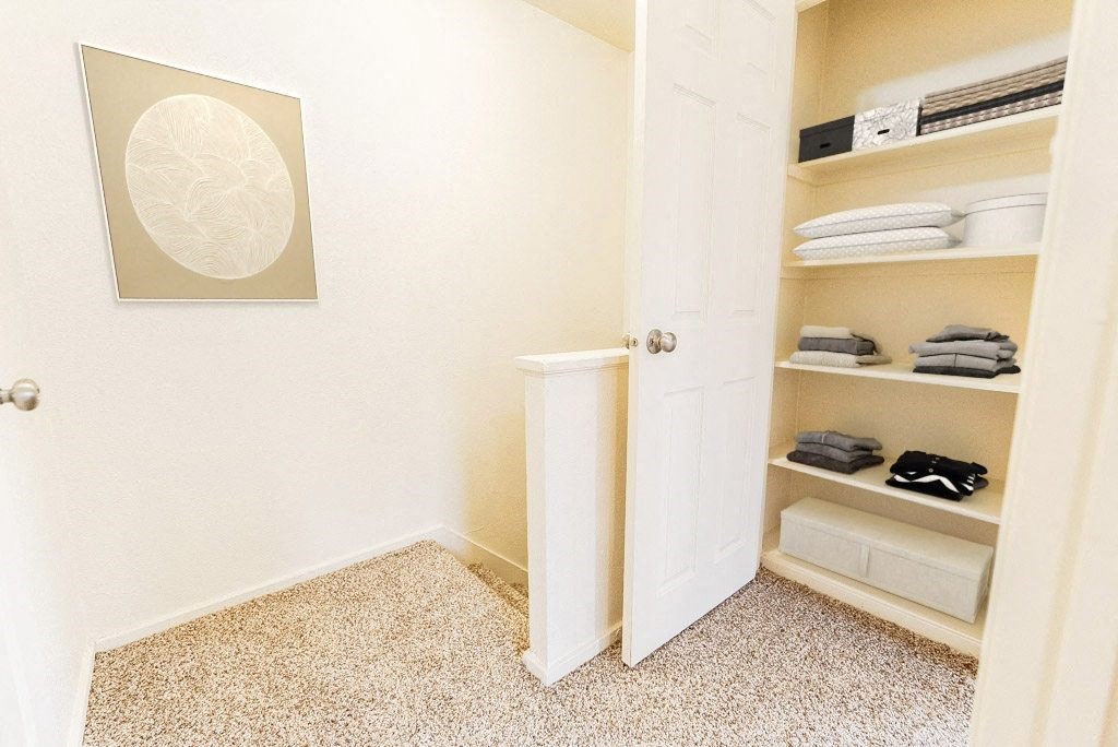 a closet with shelves and a white door