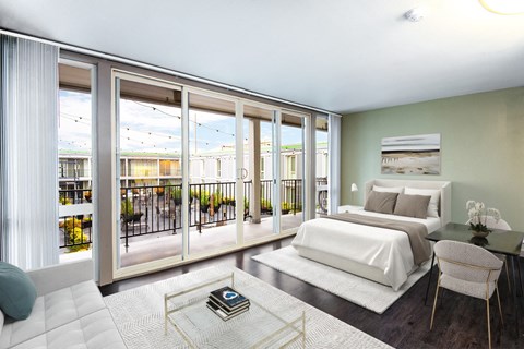 A bedroom with a large bed and a balcony with a view of the outside.