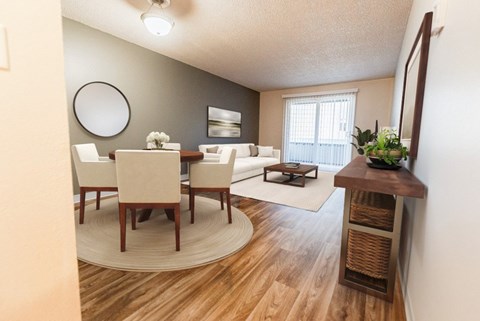 A dining room with a round table and chairs at Bellmary Park Apartments - Kitchen, Living Room, and Deck at Bellamy Park Apartments , Lakewood, 98498