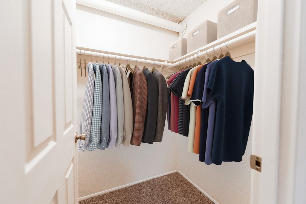 A row of clothes hanging on a rack.