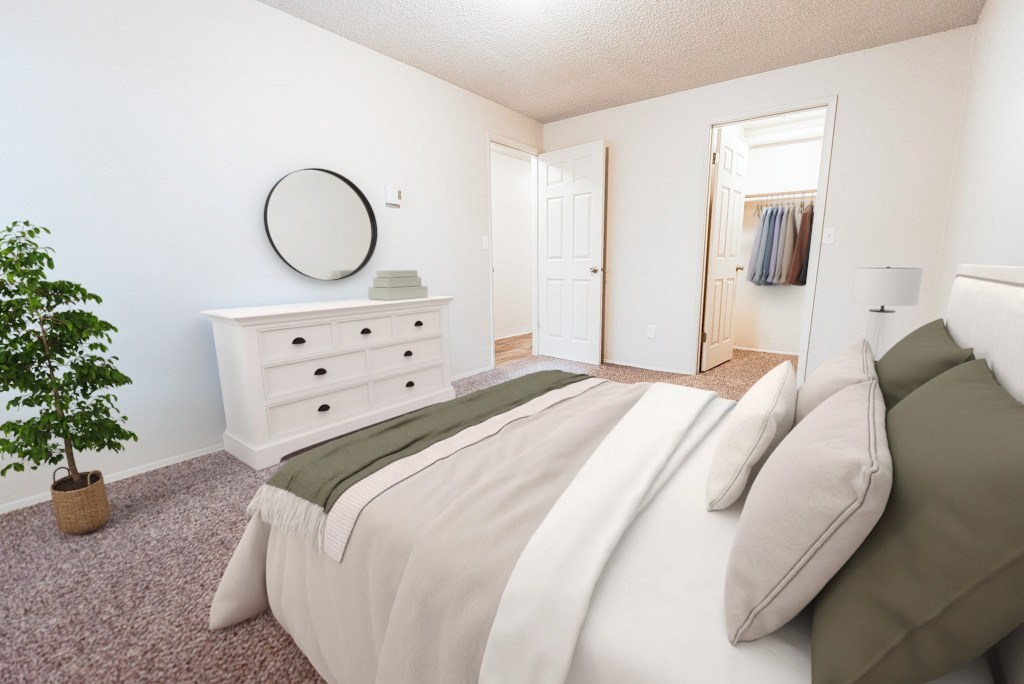 A bedroom with a bed, dresser, and mirror.