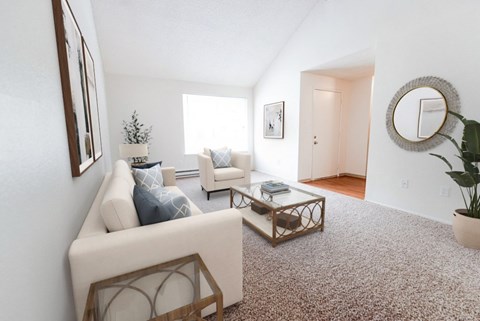 A living room with a white couch and a coffee table.