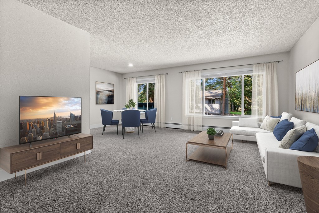 A modern living room with a large TV and comfortable seating.