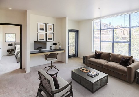A living room with a brown couch, a chair, and a coffee table.