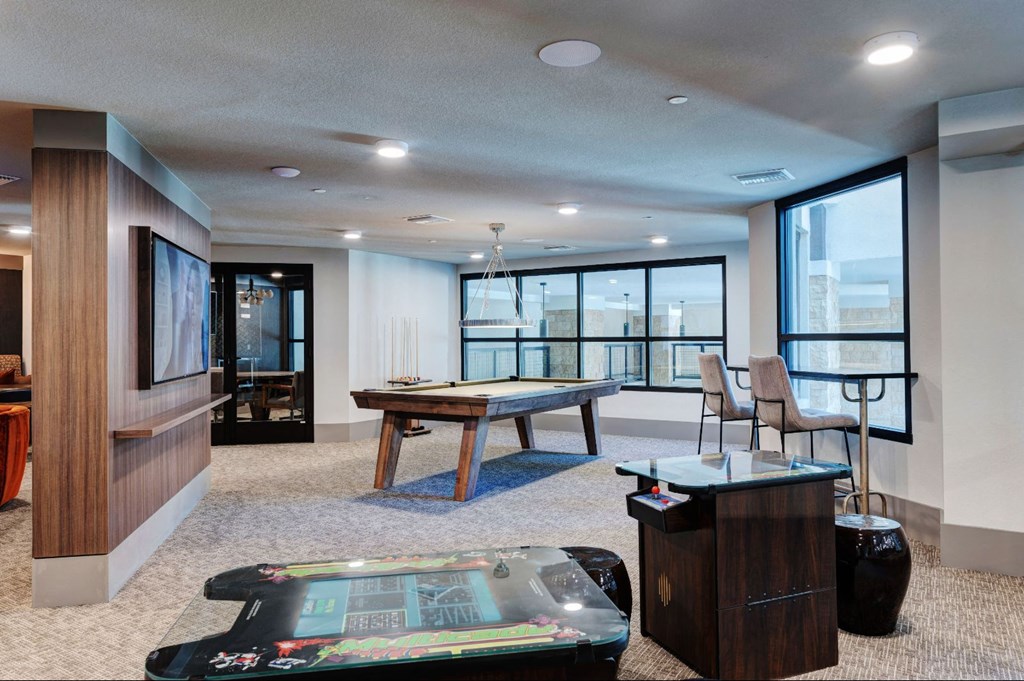 a game room with a pool table and a view of the city at Scottsdale Grand, Arizona