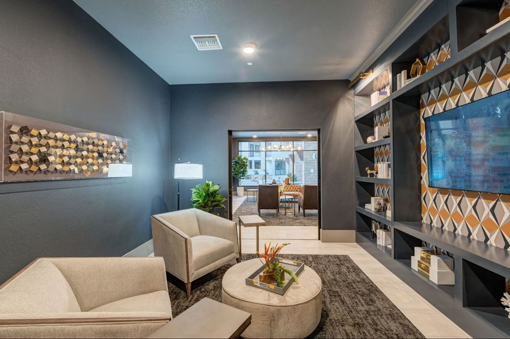 a living room with a couch and chairs and a tv at Scottsdale Grand, Arizona