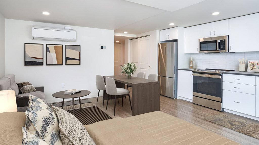A modern kitchen with a dining table and chairs.