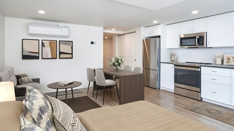 A modern kitchen with a dining table and chairs.