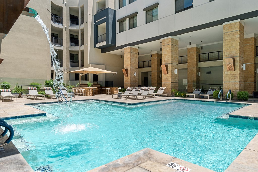 a swimming pool with a building in the background