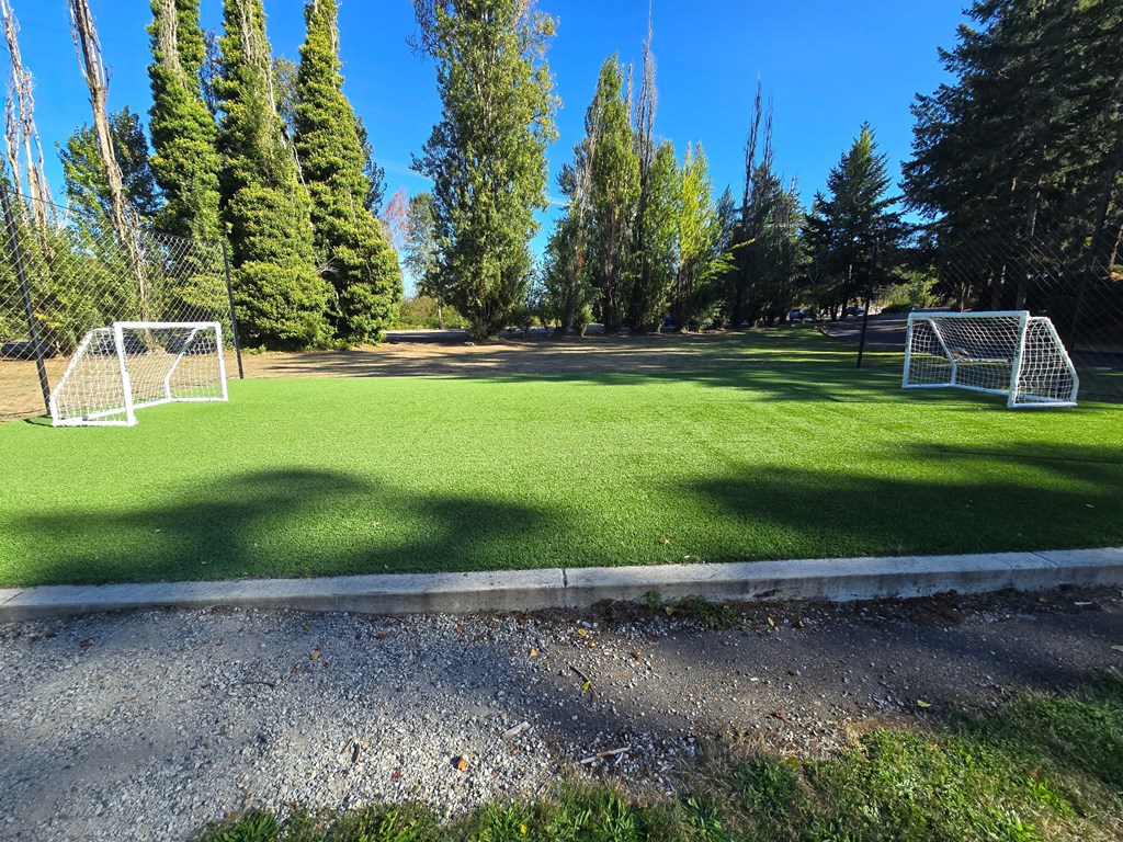A soccer field with two goal posts and a goal net.