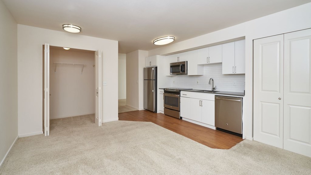 A kitchen with white cabinets and appliances is shown.