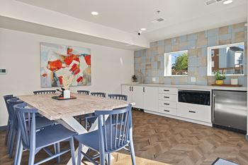 a kitchen and dining room with blue chairs and a table