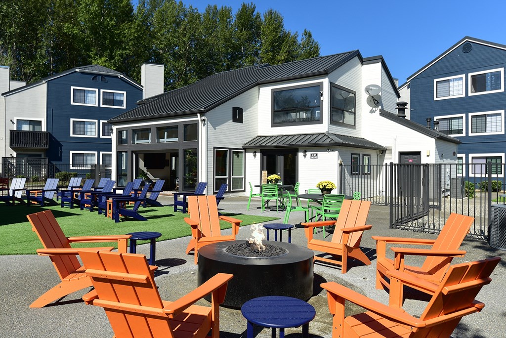 an outdoor patio with chairs and a fire pit