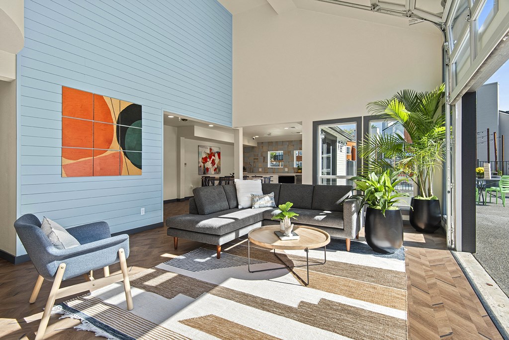 a living room with blue walls and furniture and a sliding glass door