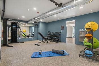 a workout room with weights and cardio equipment at the flats
