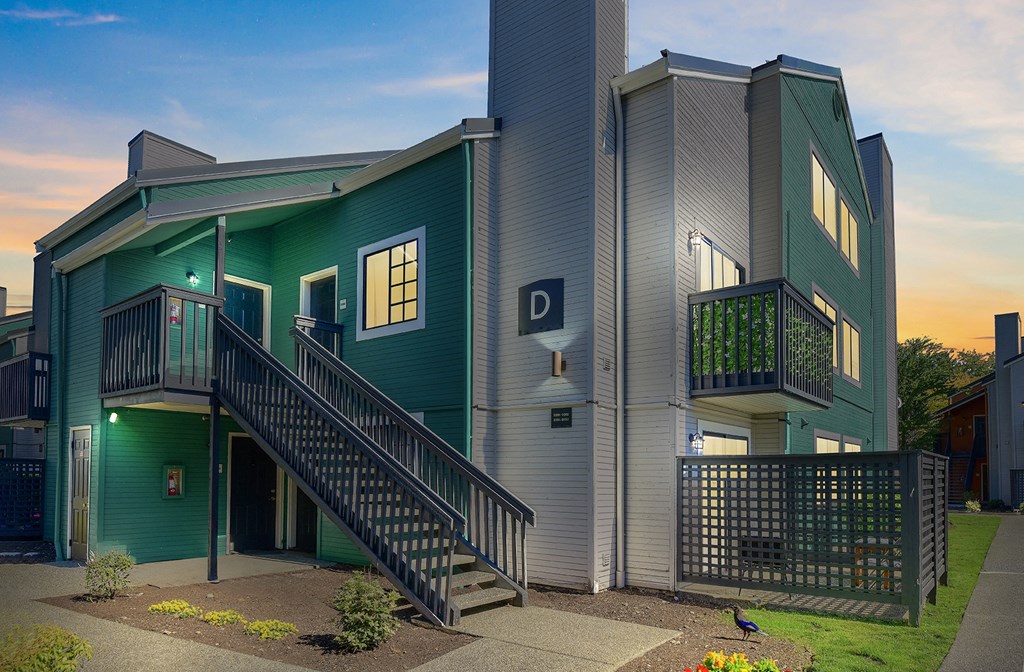 a green building with stairs and a d sign