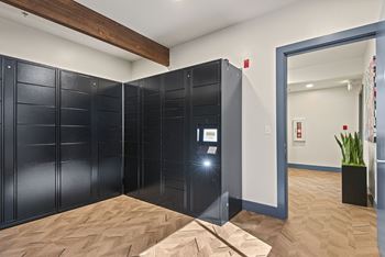 a pair of black lockers in a room with a wood floor