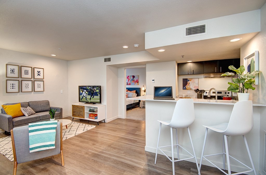 Kent Apartments- Astral Apartments- barstools, kitchen, sitting area