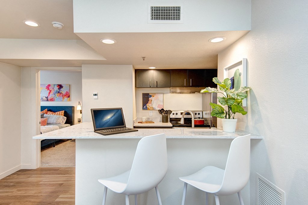 Kent Apartments- Astral Apartments- Kitchen- stainless steel- bar stool sitting area