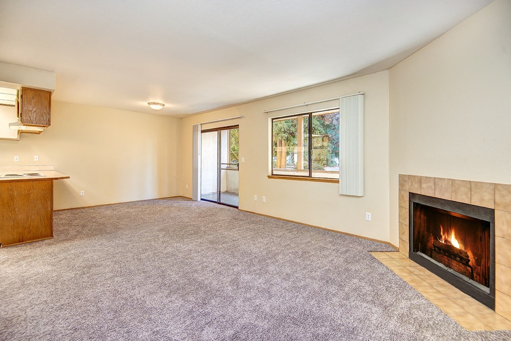 Milton Apartments - Autumn Village Apartments - Living Room, Fireplace, Kitchen, and Deck