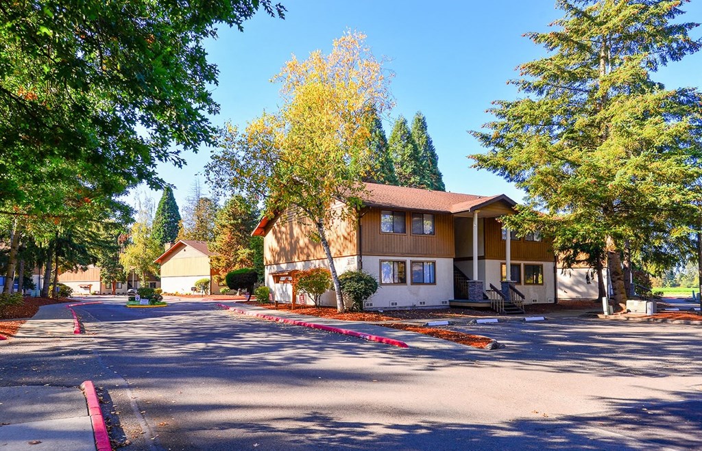 A house with a brown roof is surrounded by trees. at Autumn Village, Washington