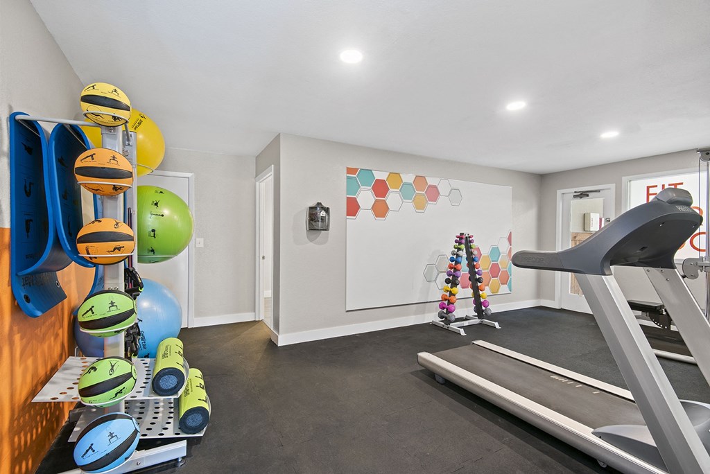 the gym at the enclave at woodbridge apartments in sugar land, tx