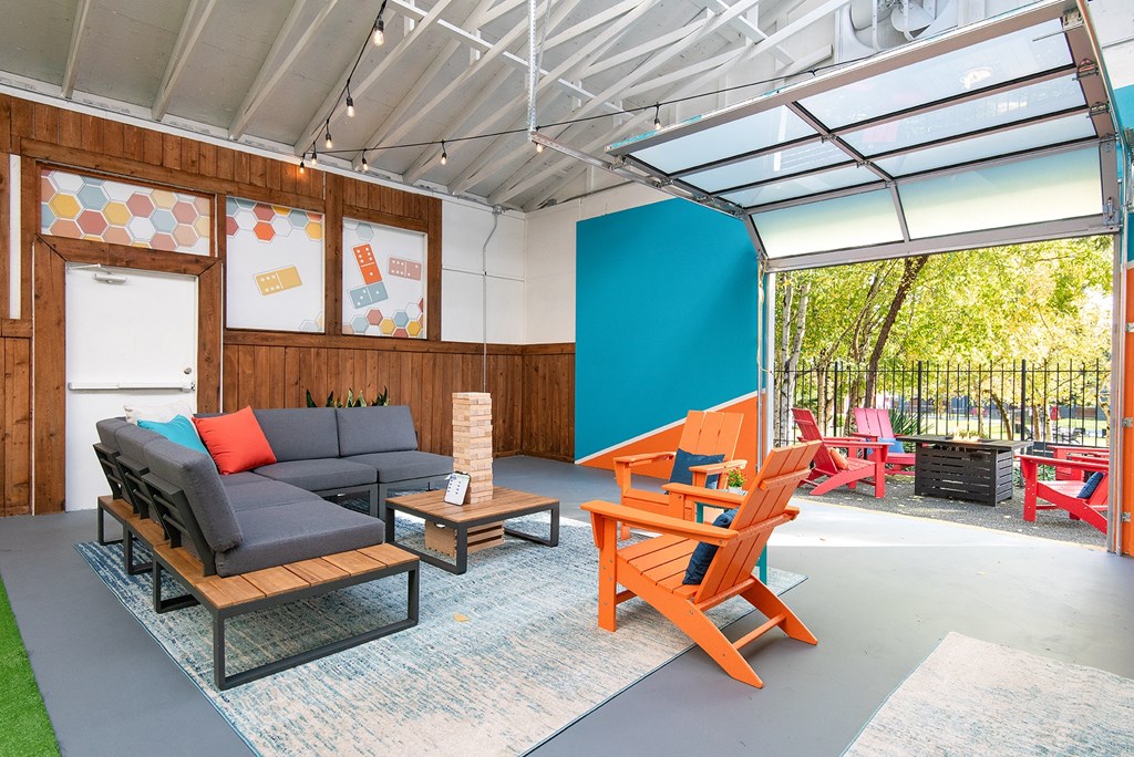 a living room with a couch and a table and chairs