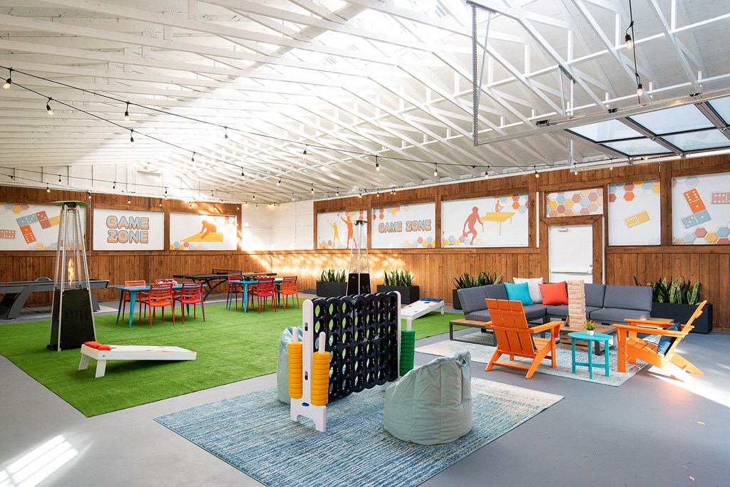 a room with couches and tables and chairs and a rug