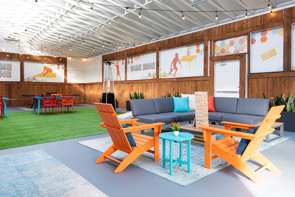 a lounge area with couches and chairs and a table