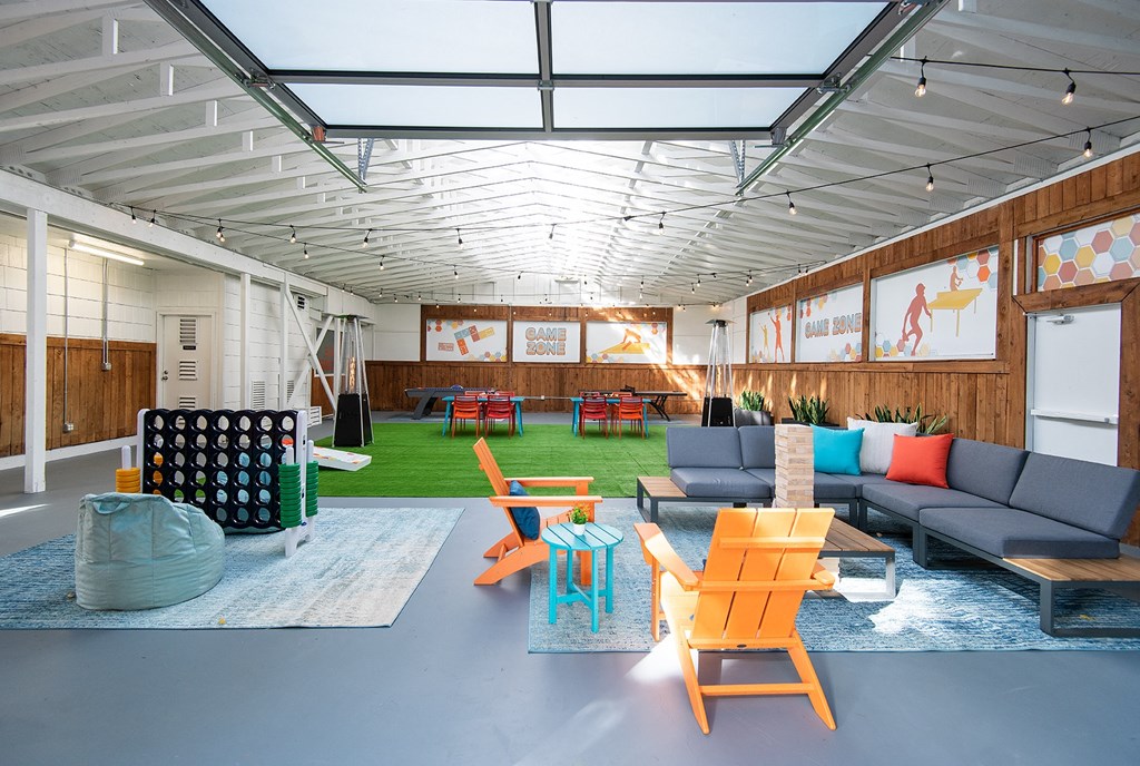 a living room with couches and chairs and a rug
