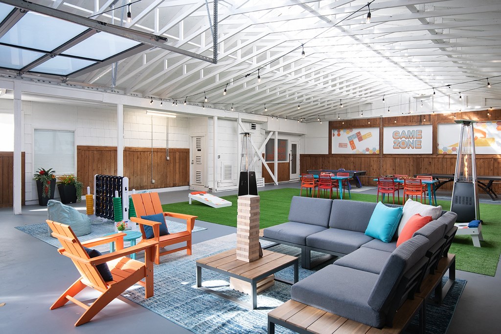 a living room with couches and chairs and a rug