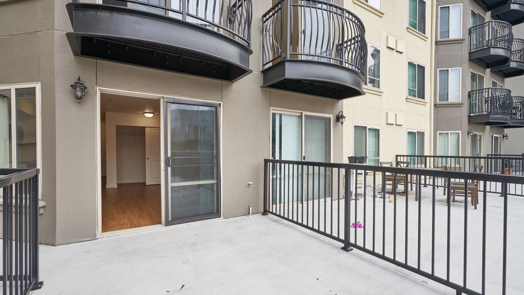A balcony with black railings and a white floor.